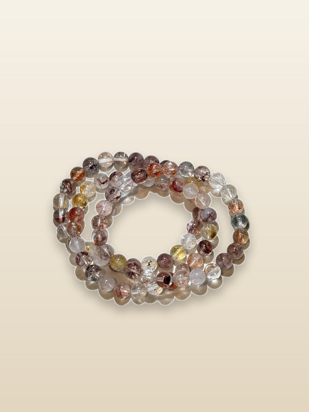 Fire quartz with Herkimer diamonds bracelet on sand background