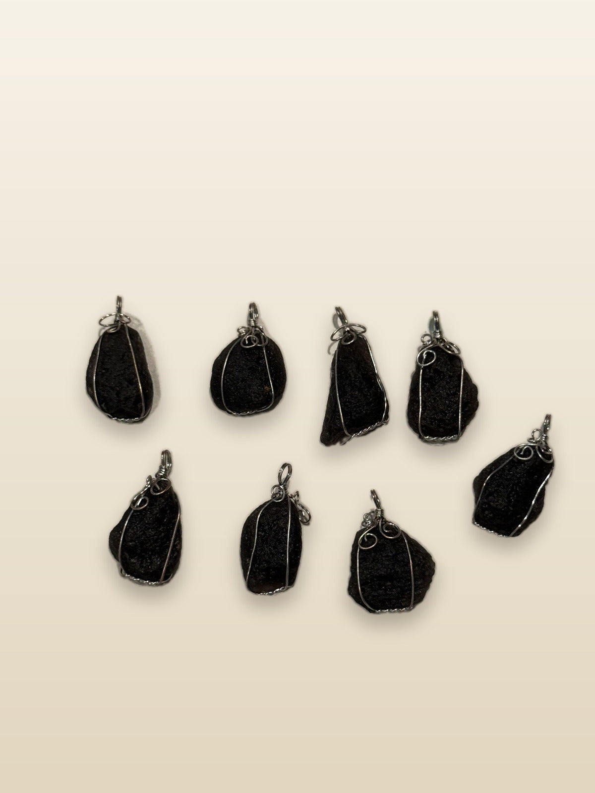 Meteorite pendant on sand-toned studio background