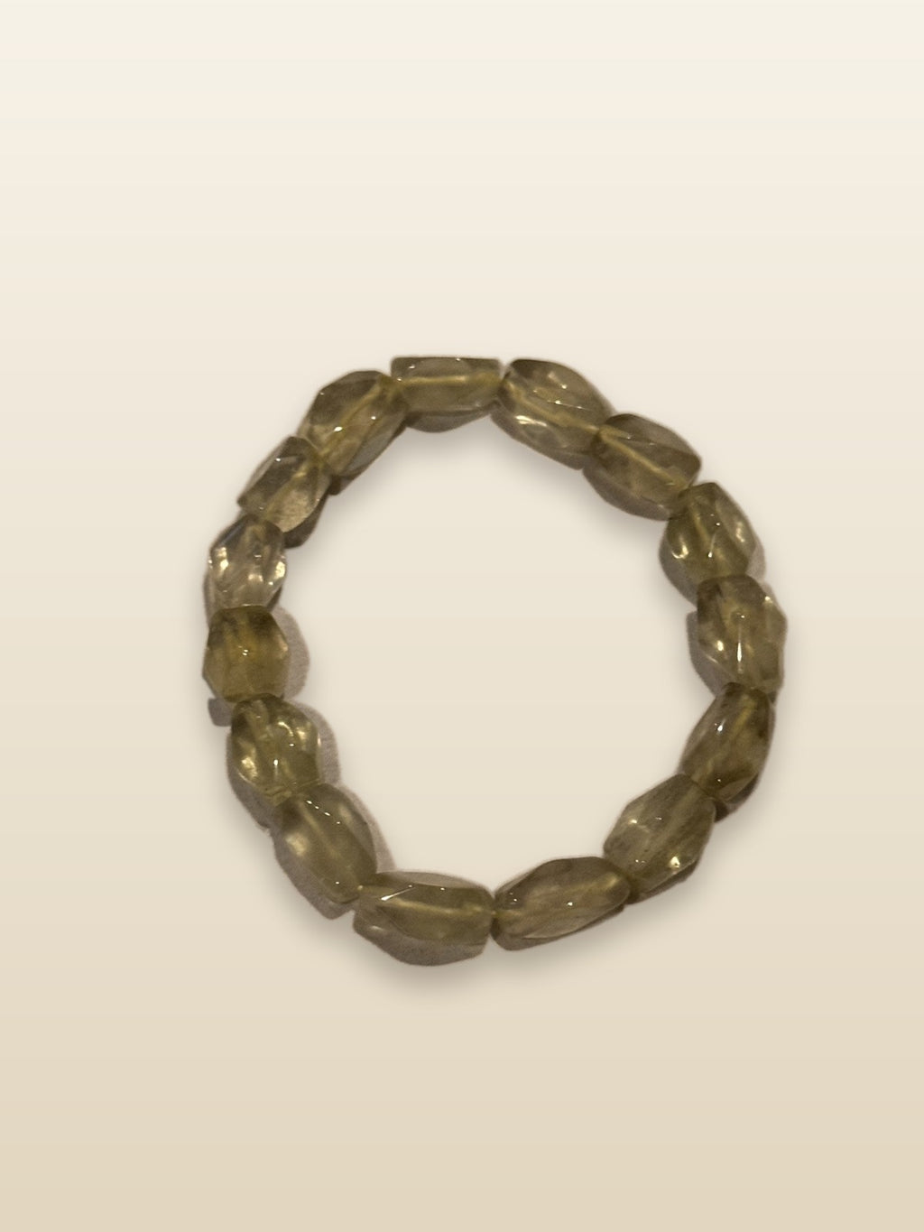 Libyan desert glass bracelet on sand-toned studio background