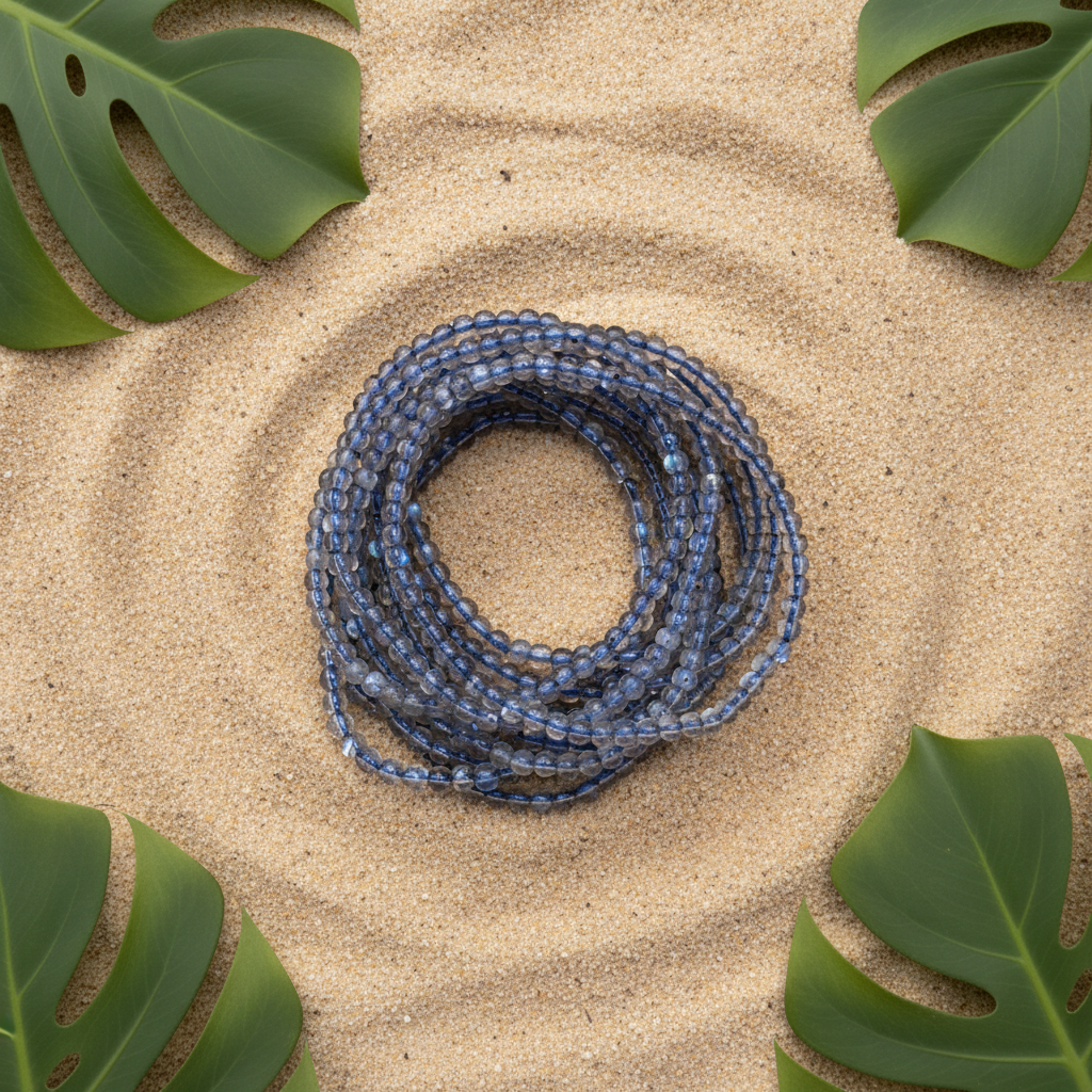 Original bracelet preserved on warm beach sand with tropical leaves
