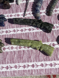 Carved stone long-gun figurines