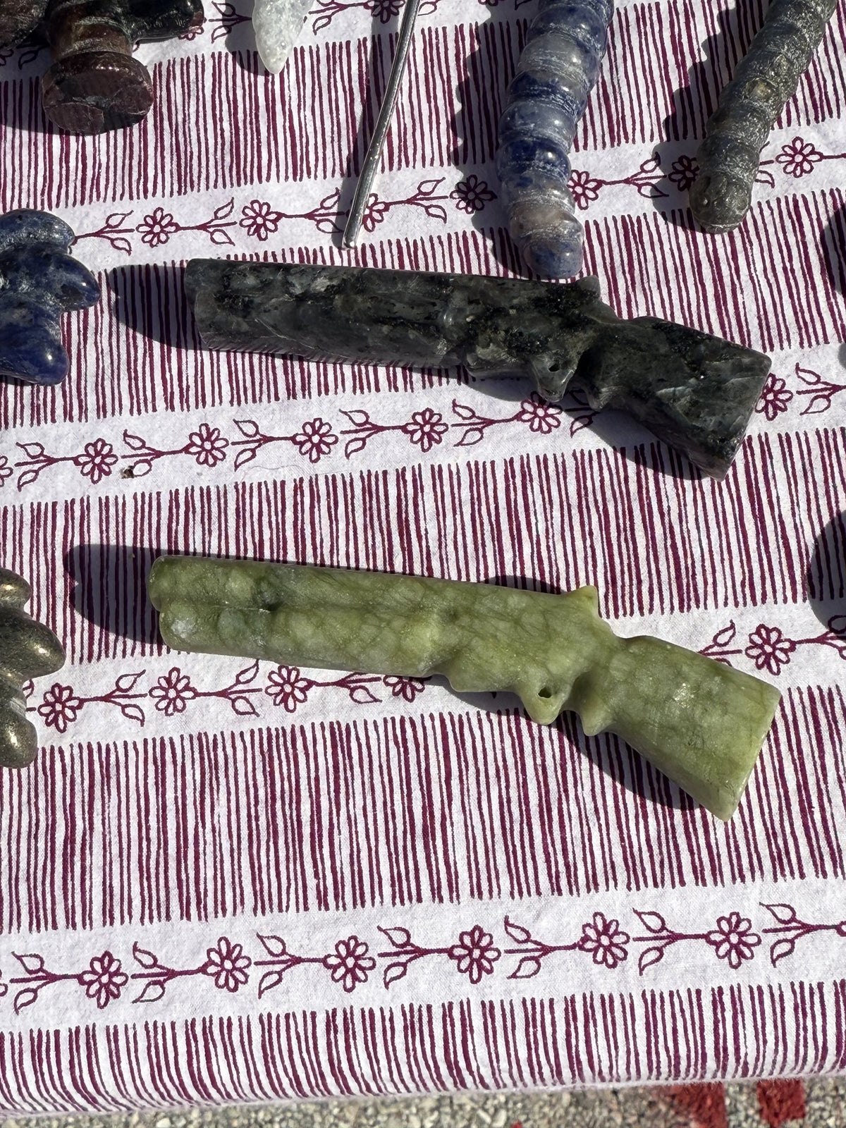 Carved stone long-gun figurines